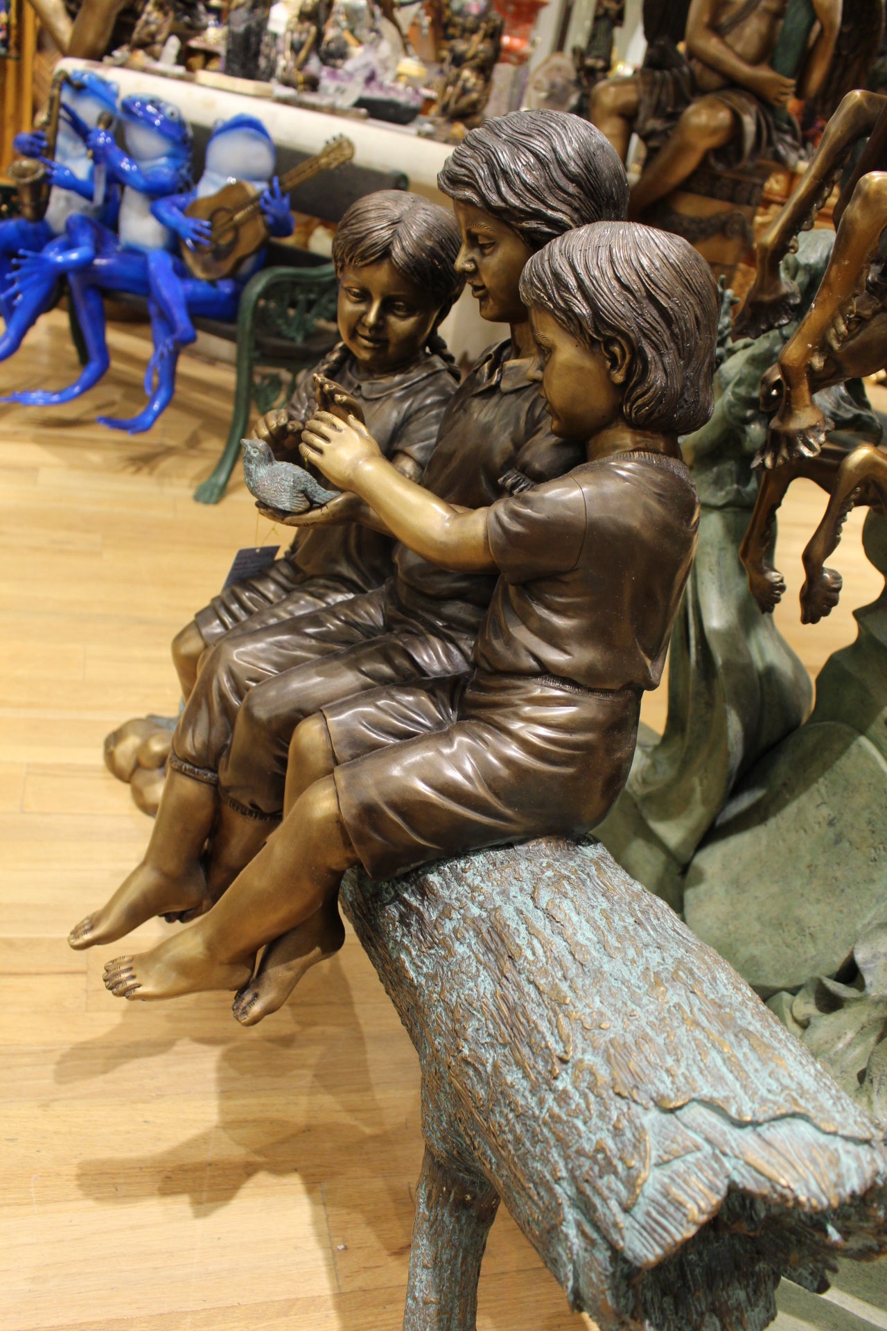 Three Children On Log Holding Bird Bronze Statue - Size: 55"L x 18"W x 38"H.