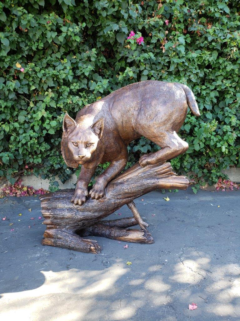 Bobcat Going Down a Tree Log Bronze Statue - Size: 43"L x 25"W x 41"H.