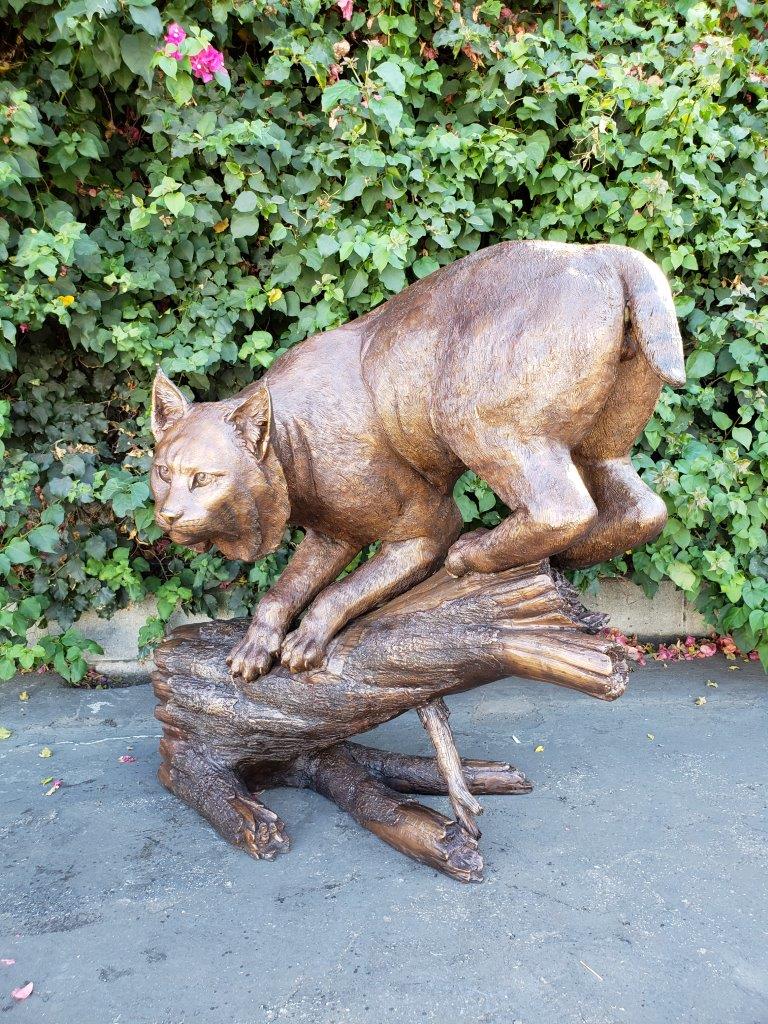 Bobcat Going Down a Tree Log Bronze Statue - Size: 43"L x 25"W x 41"H.