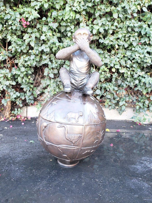 Bronze Statue of a Monkey on an Ornate Ball - Size: 23"L x 23"W x 44"H.