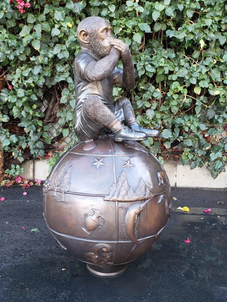 Bronze Statue of a Monkey on an Ornate Ball -  Size: 23"L x 23"W x 44"H.