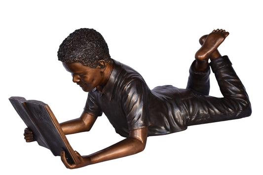 African American Boy reading a book bronze statue - Size: 42"L x 15"W x 19"H.
