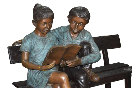 Boy and a Girl on Bench reading book bronze Statue - Size: 43"L x 20"W x 36"H.