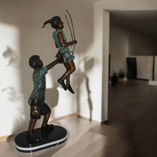 Children-on-swing-Bronze-Statue - Size: 20"L x 9"W x 39"H.