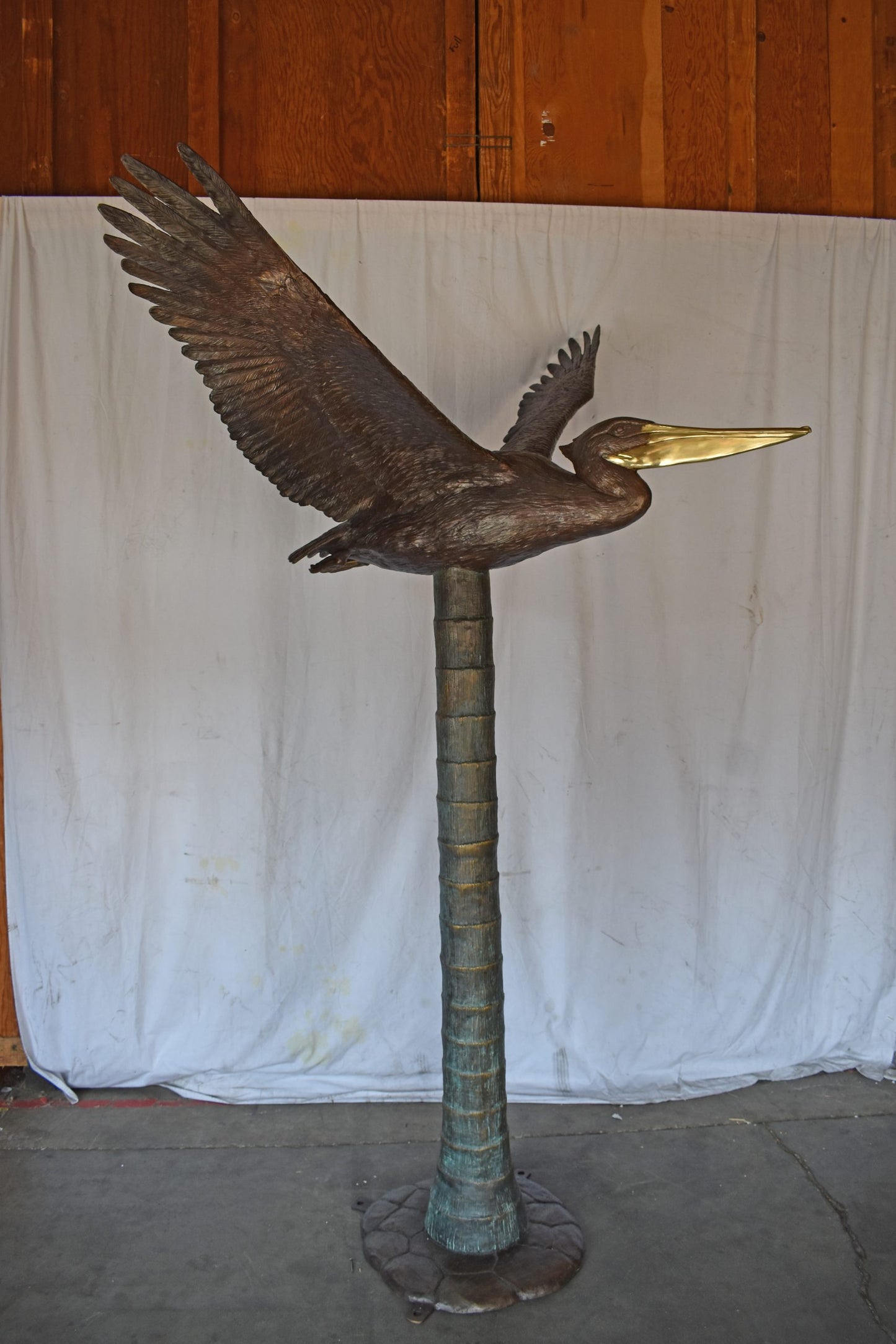 Life Size Pelican on a Three Bronze Statue - Size: 55"L x 46"W x 60"H.