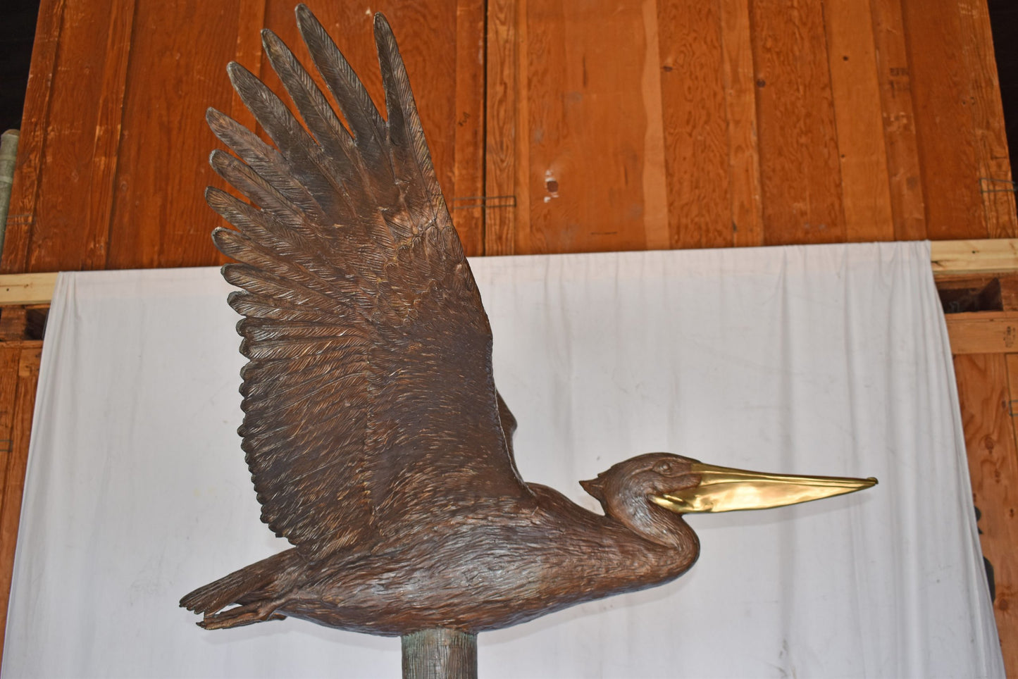 Life Size Pelican on a Three Bronze Statue - Size: 55"L x 46"W x 60"H.
