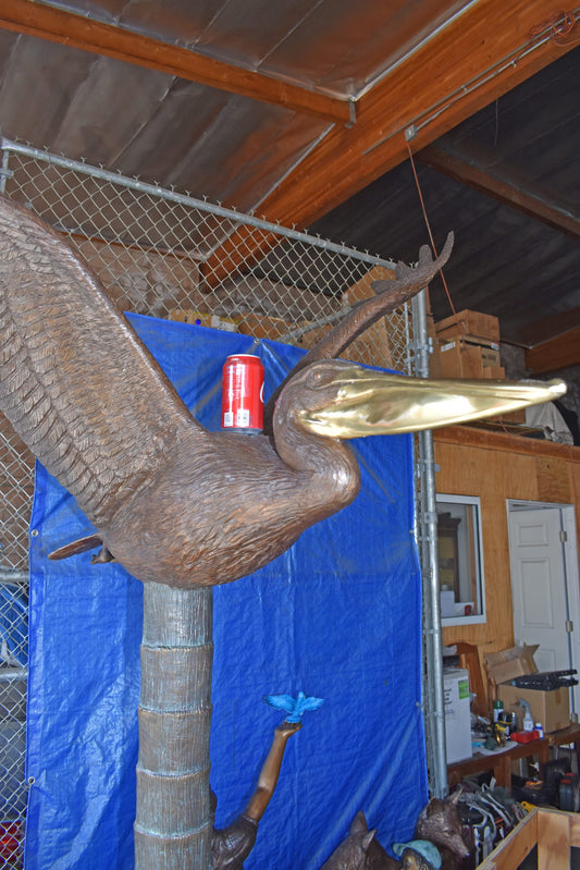 Life Size Pelican on a Three Bronze Statue - Size: 55"L x 46"W x 60"H.