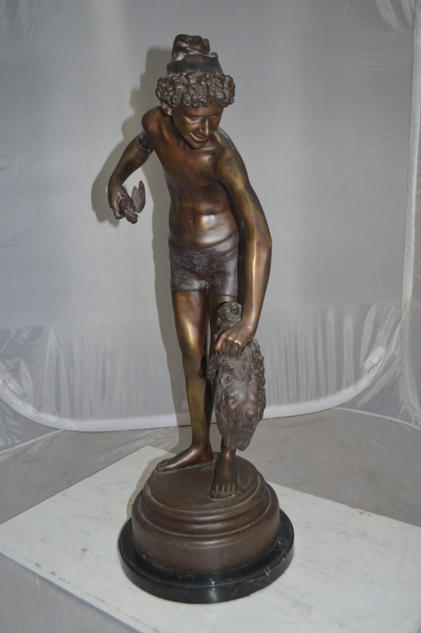 Boy holding a Dog and a Bird Bronze Statue -  Size: 15"L x 15"W x 36"H.