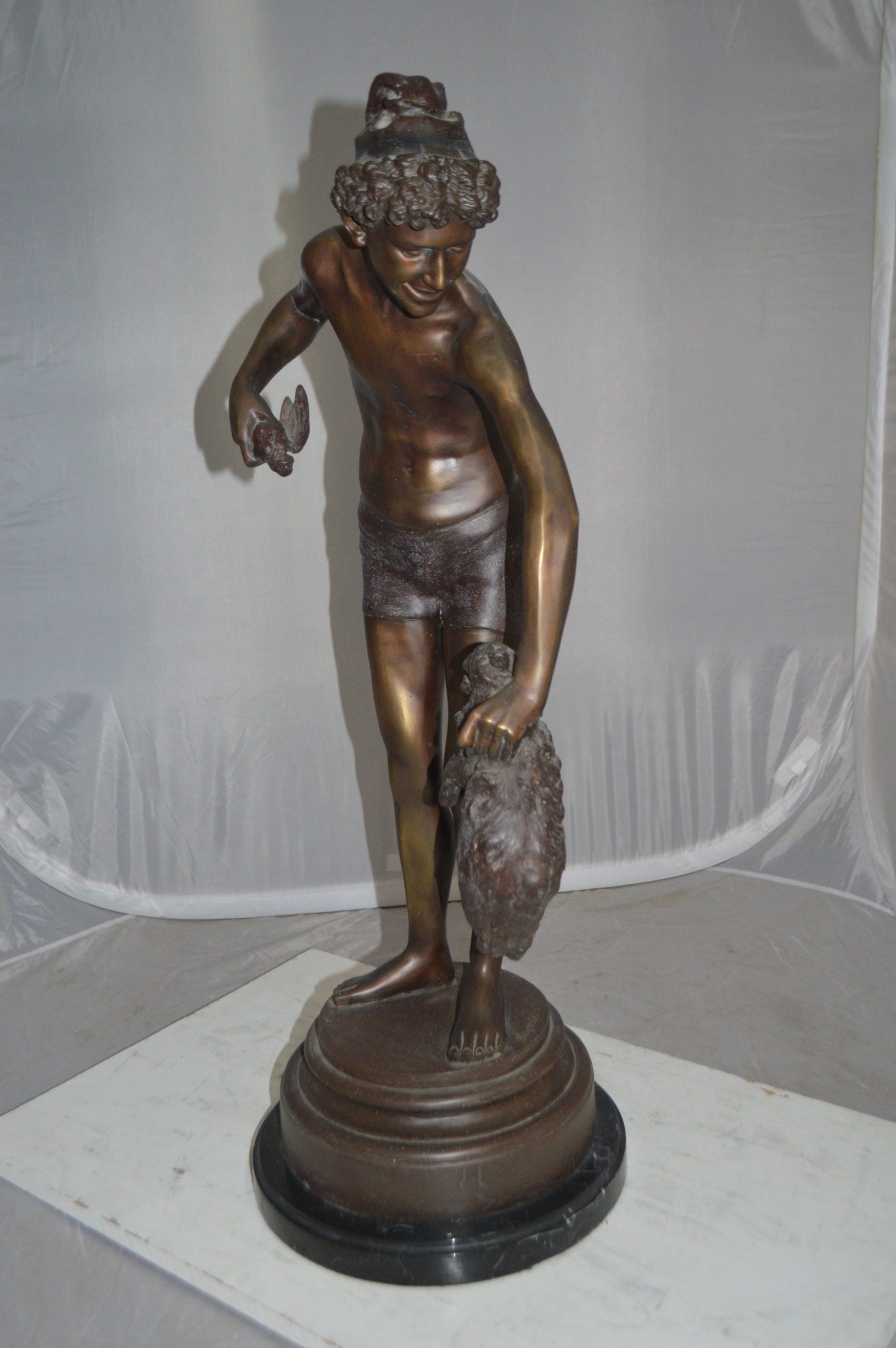 Boy holding a Dog and a Bird Bronze Statue -  Size: 15"L x 15"W x 36"H.