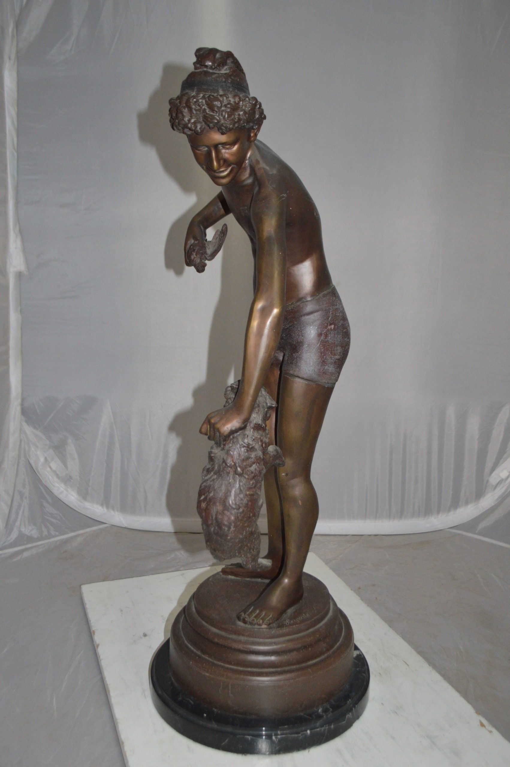 Boy holding a Dog and a Bird Bronze Statue -  Size: 15"L x 15"W x 36"H.