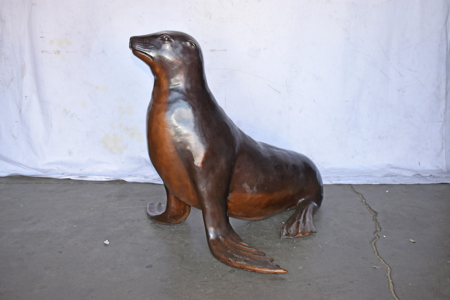 Perched Life Size Seal bronze statue - Size: 40"L x 35"W x 31"H.