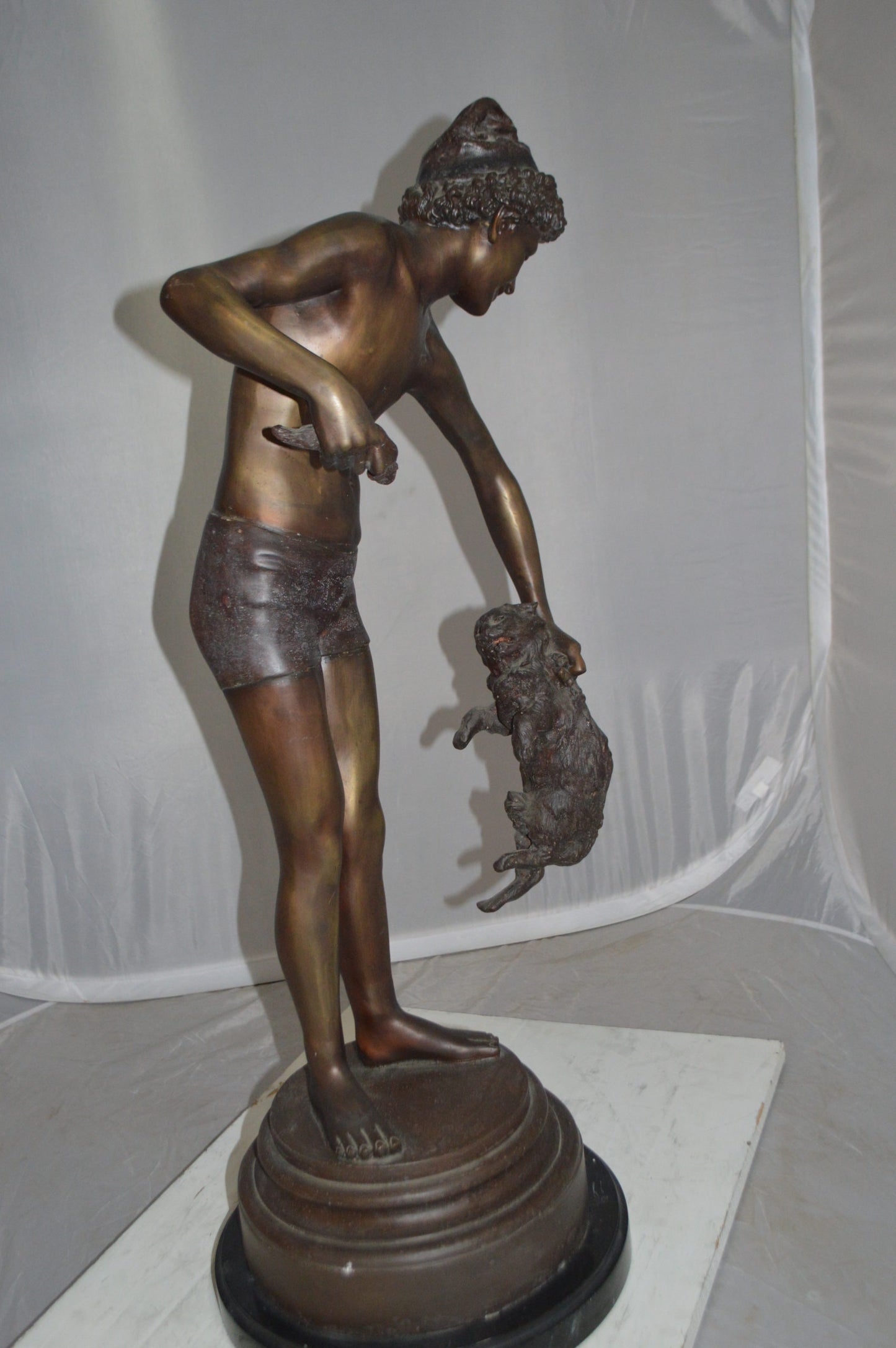 Boy holding a Dog and a Bird Bronze Statue - Size: 15"L x 15"W x 36"H.
