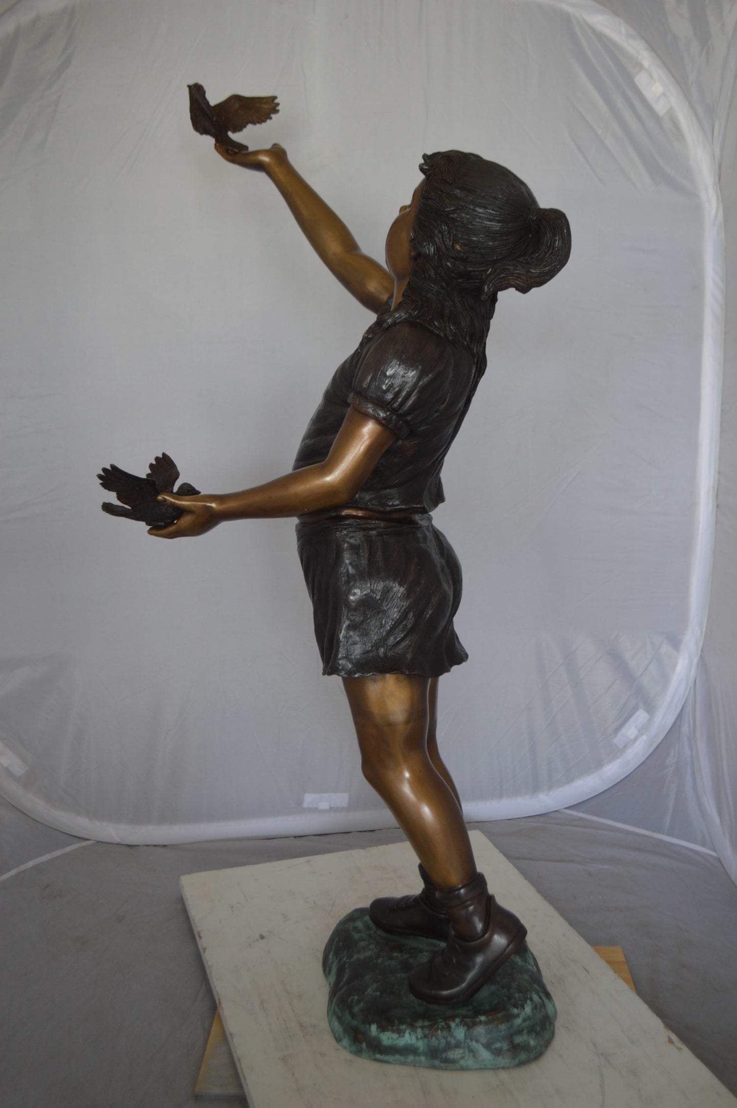 Girl - sandy, with two birds Bronze Statue - Size: 25"L x 20"W x 42"H.