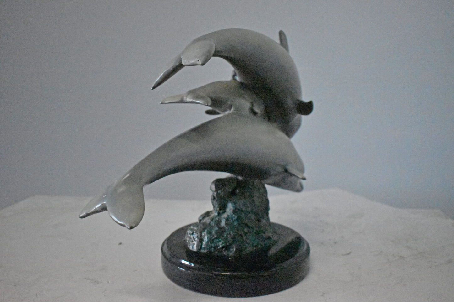 Three Grey Dolphins Swimming Bronze Statue on Marble - Size: 16"L x 9"W x 13"H.