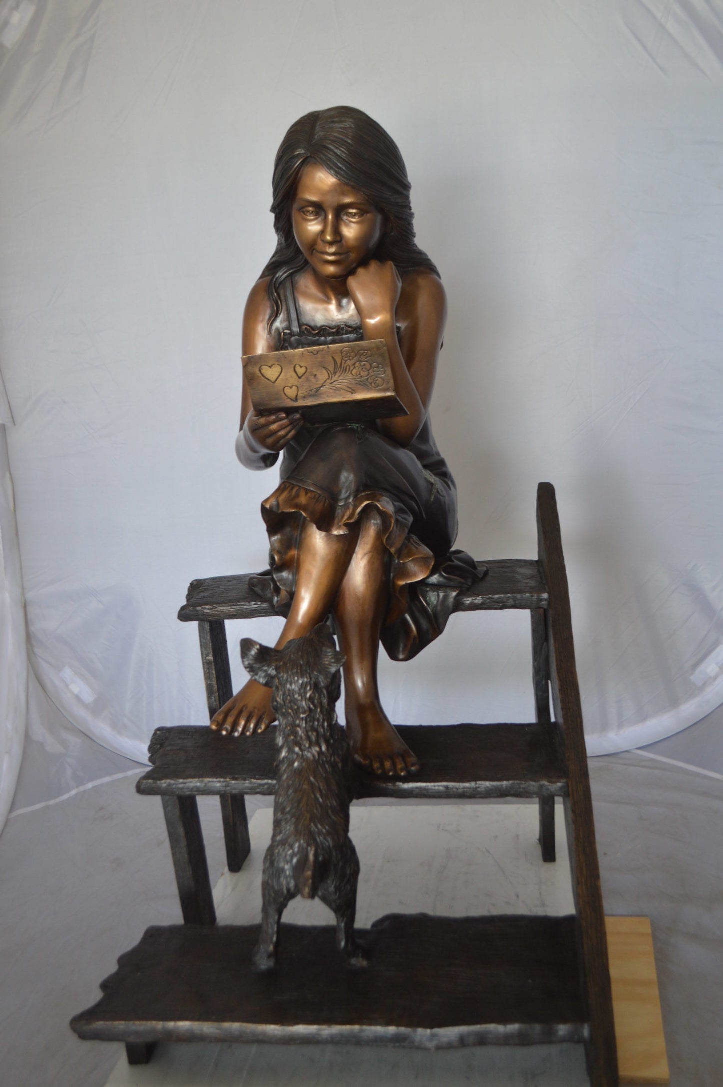 Girl Reading Letters on the Stairs Bronze Statue - Size: 32"L x 22"W x 40"H.