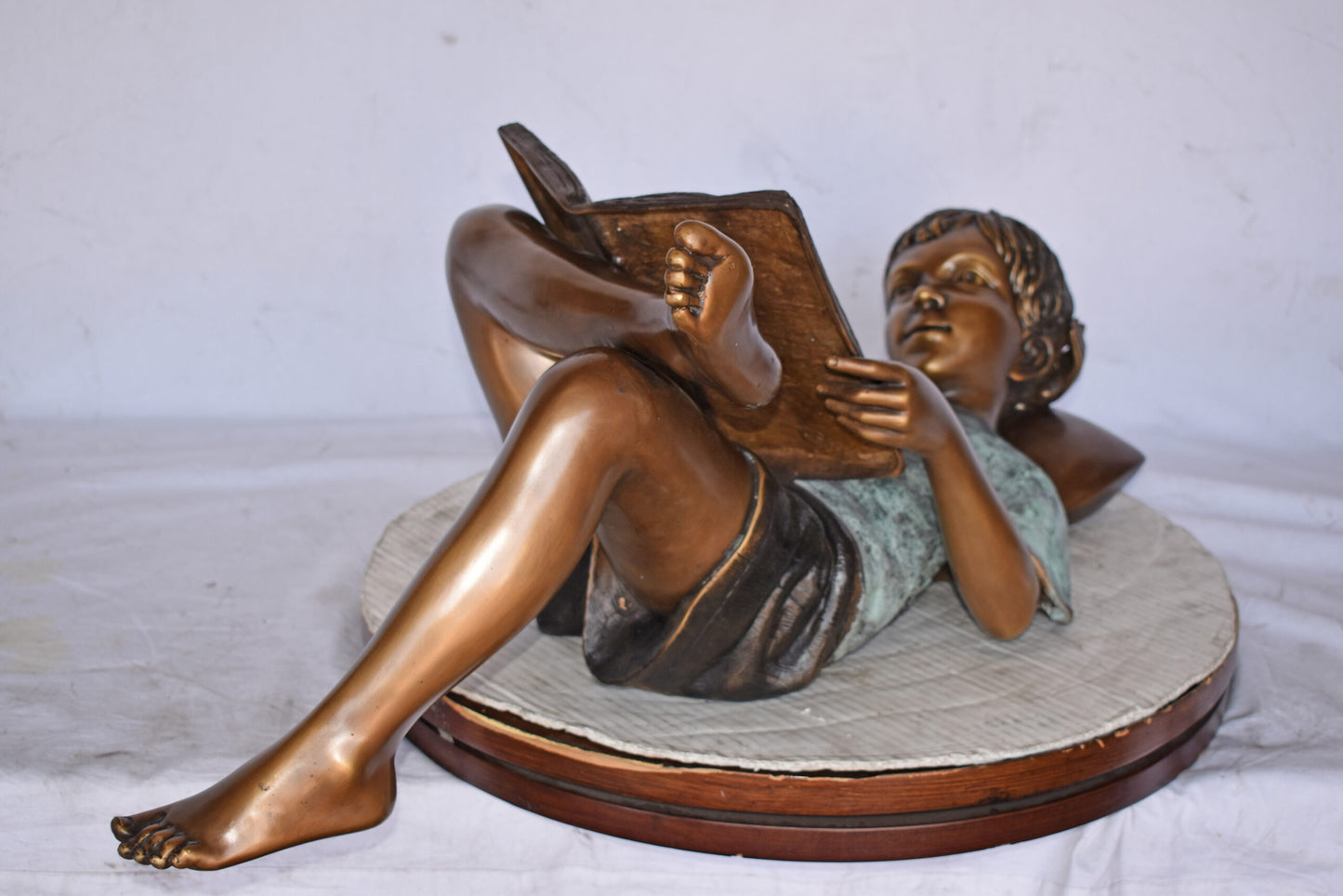 Kid on A Pillow Reading a Book Bronze Statue - Size: 32"L x 13"W x 12"H.