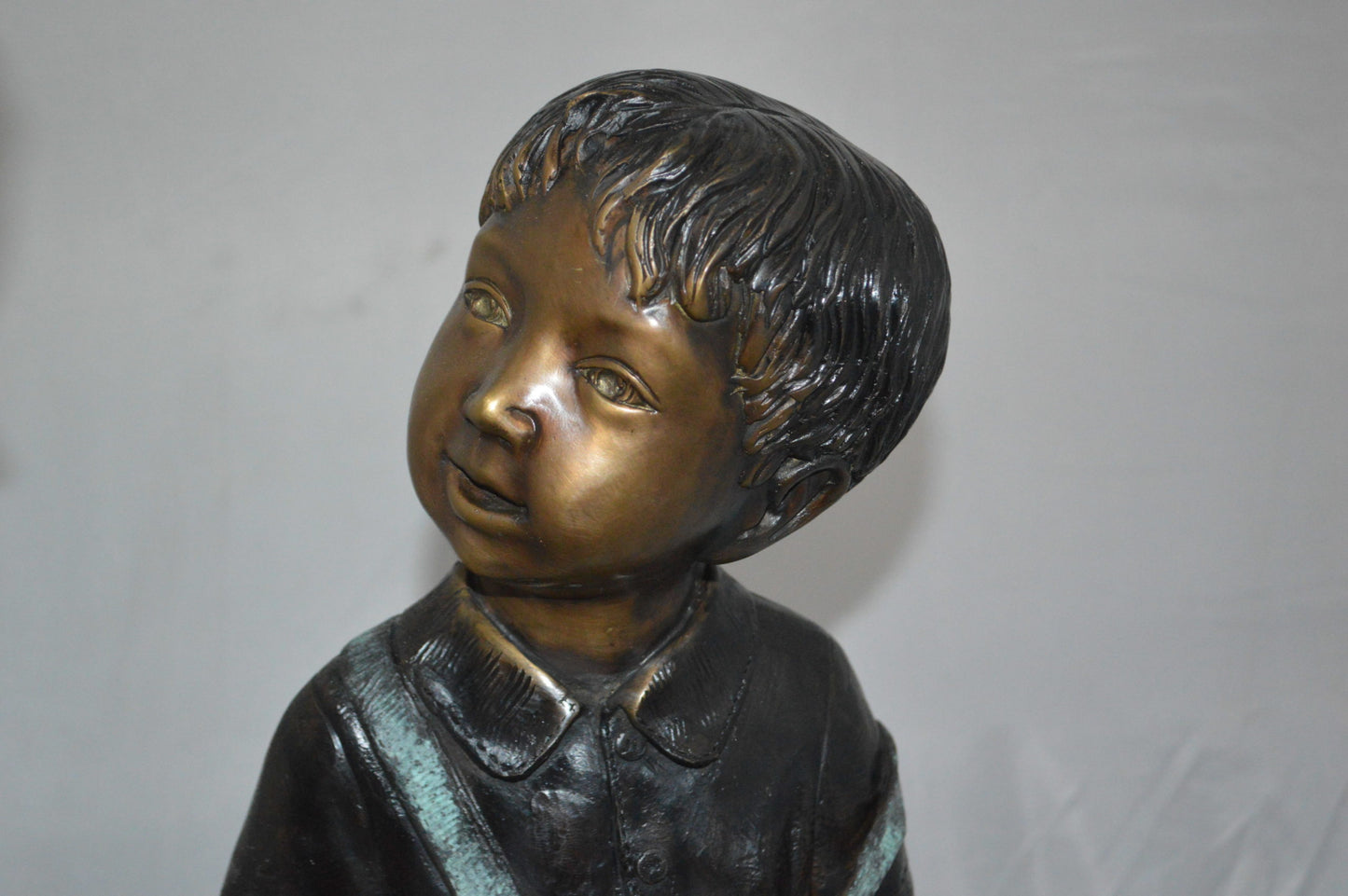 Boy and Girl on a tree log reading Bronze Statue - Size: 37"L x 14"W x 27"H.
