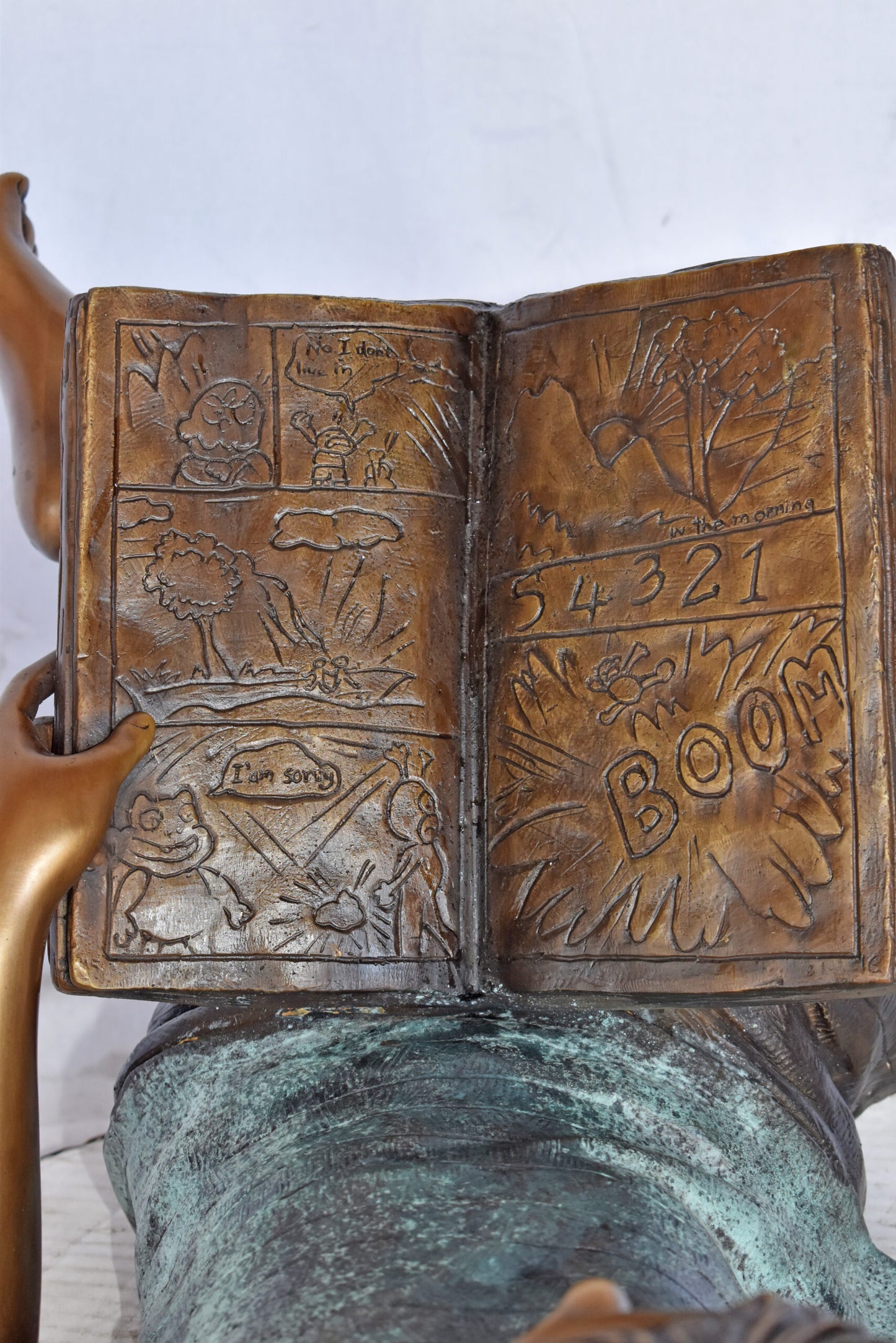 Kid on A Pillow Reading a Book Bronze Statue - Size: 32"L x 13"W x 12"H.