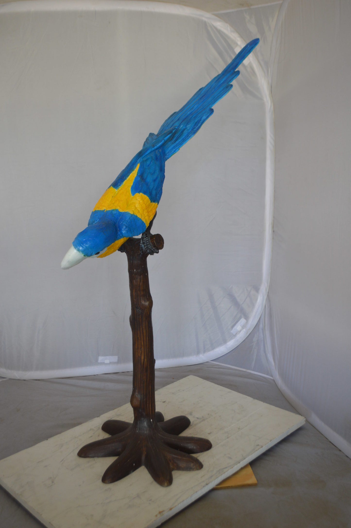 Parrot on Tree - Head Down Bronze Statue - Size: 39"L x 15"W x 47"H.