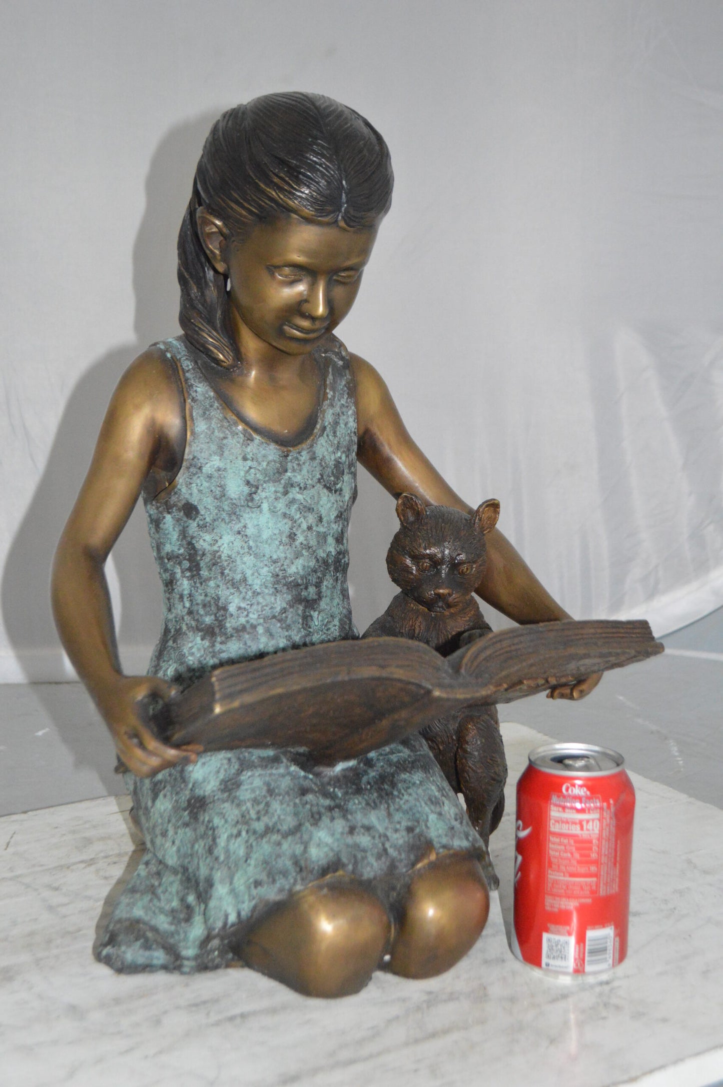 Girl and her dog reading a book Bronze Statue -  Size: 20"L x 8"W x 14"H.
