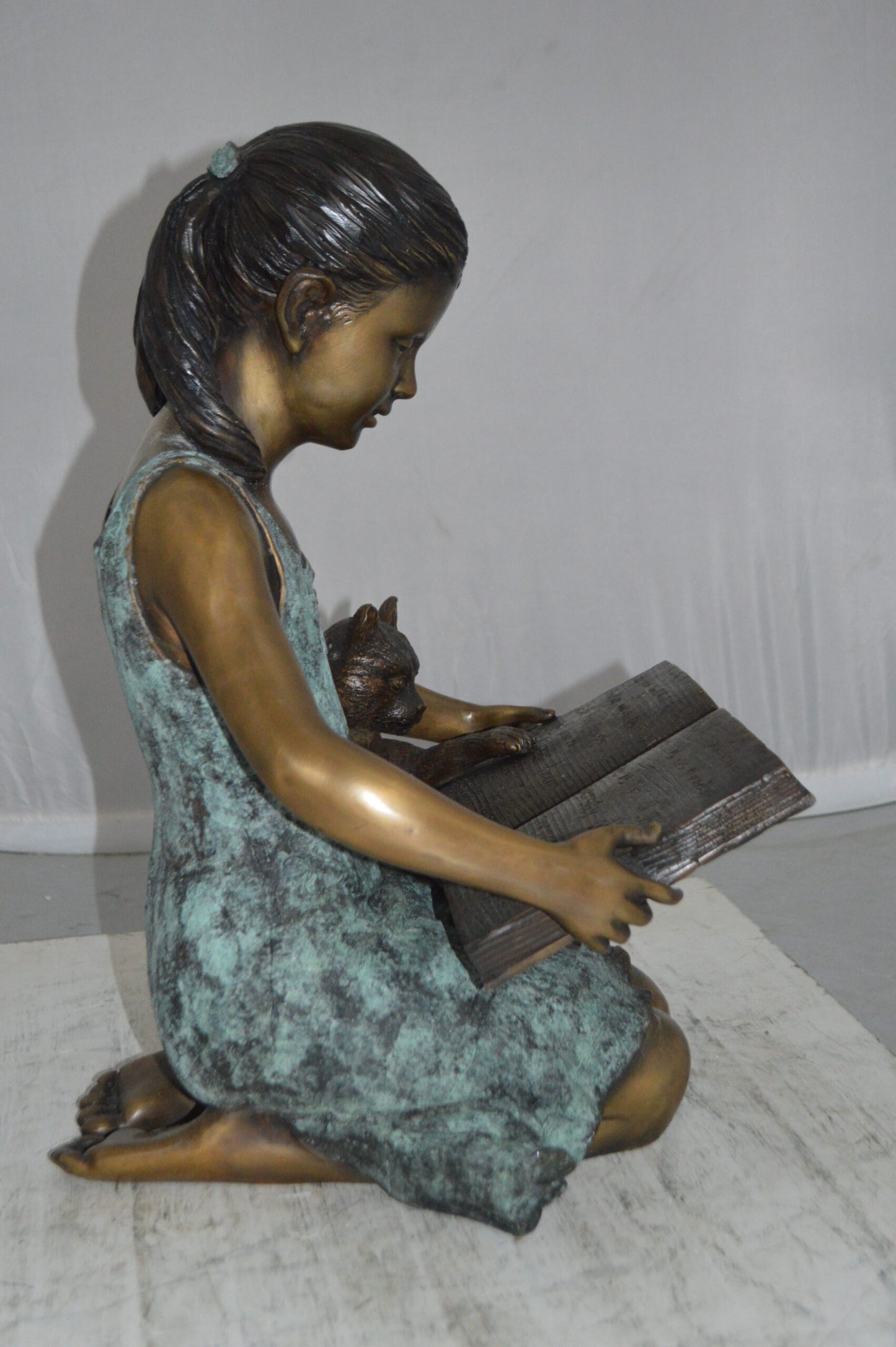 Girl and her dog reading a book Bronze Statue - Size: 20"L x 8"W x 14"H.