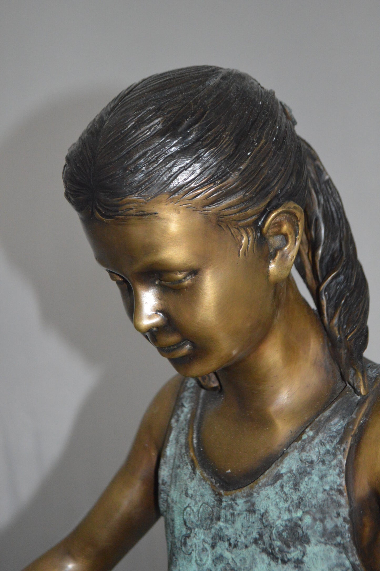 Girl and her dog reading a book Bronze Statue -  Size: 20"L x 8"W x 14"H.