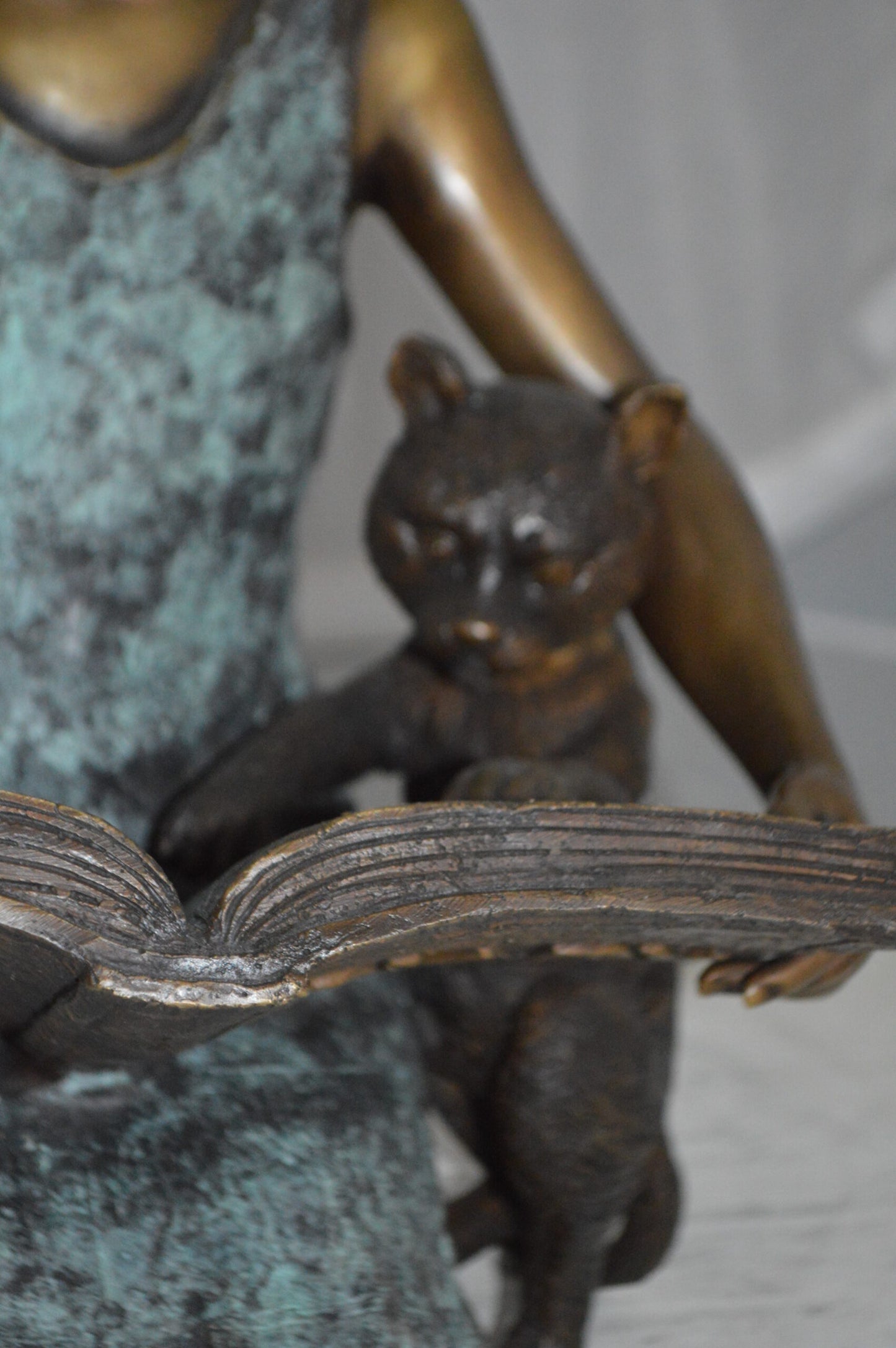 Girl and her dog reading a book Bronze Statue -  Size: 20"L x 8"W x 14"H.