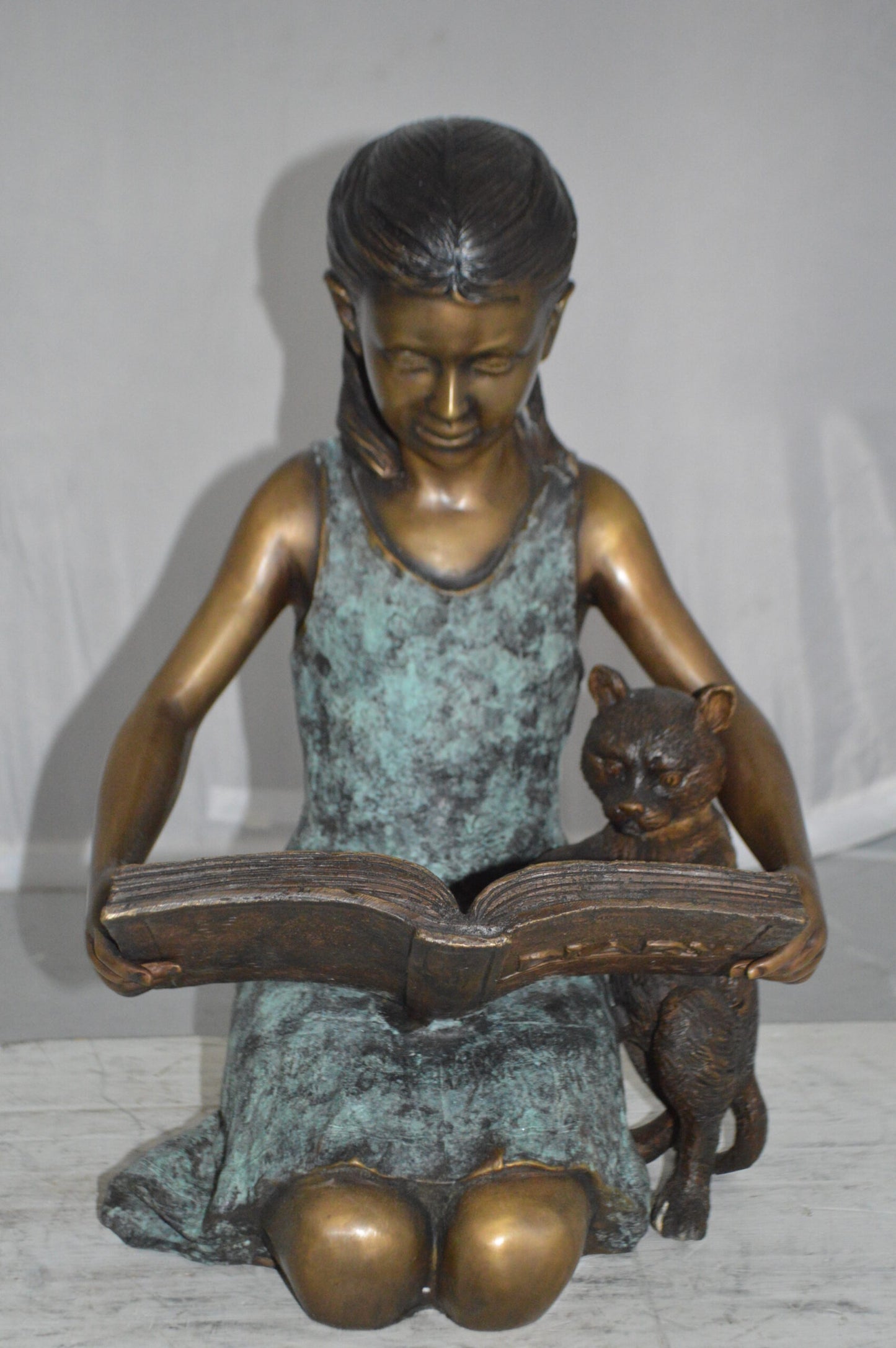 Girl and her dog reading a book Bronze Statue - Size: 20"L x 8"W x 14"H.