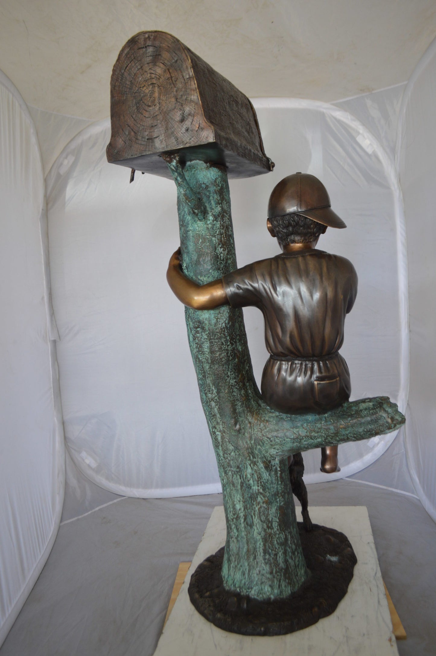 Boy Sitting on a Tree with Mailbox Bronze Statue - Size: 22"L x 23"W x 49"H.