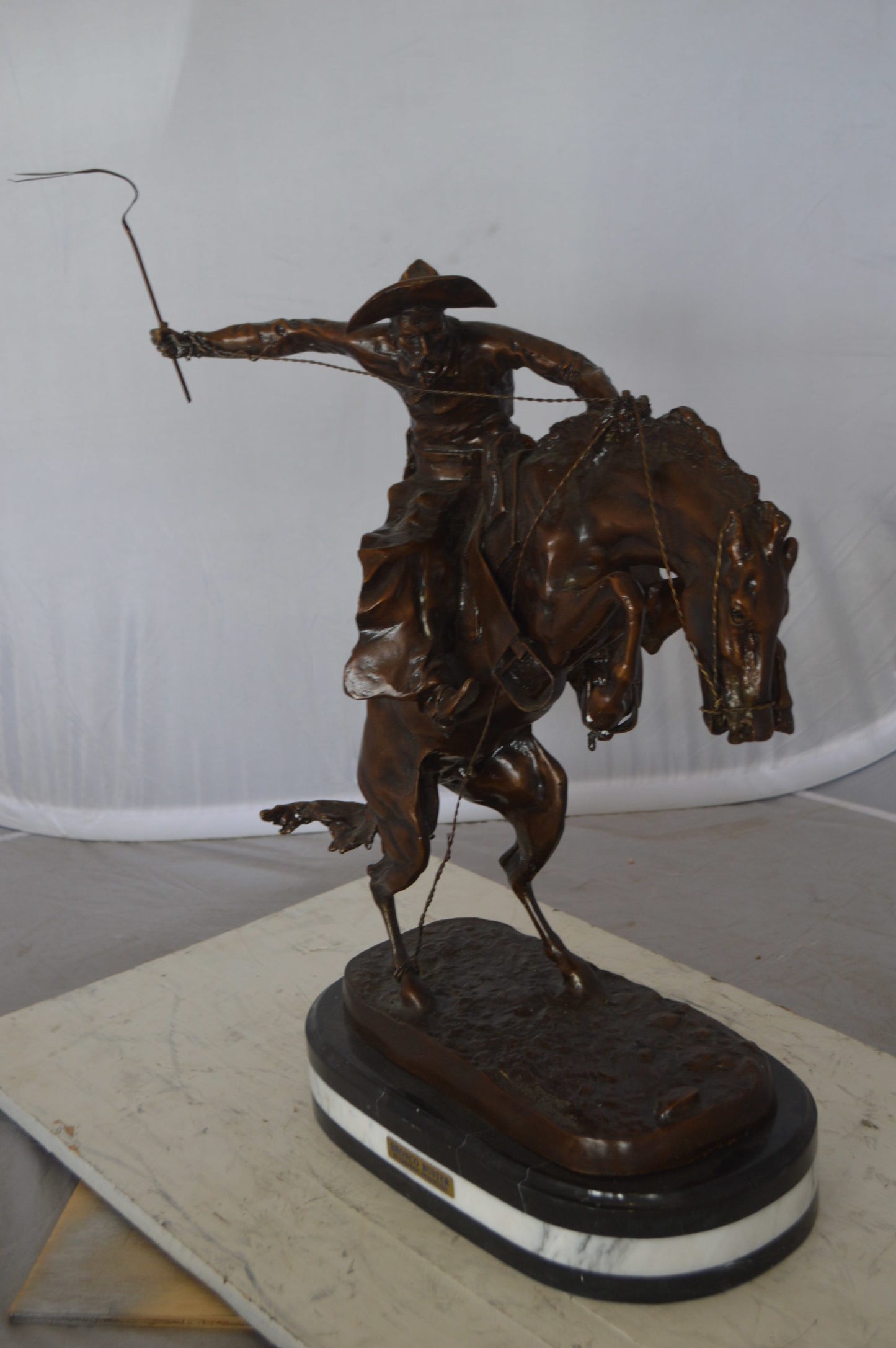 Bronco Buster by Remington Bronze Statue on a triple marble - 21"x 10"x 26"H.
