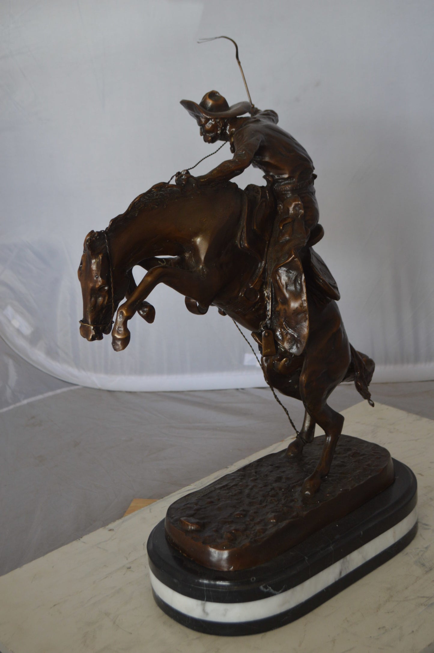 Bronco Buster by Remington Bronze Statue on a triple marble - 21"x 10"x 26"H.