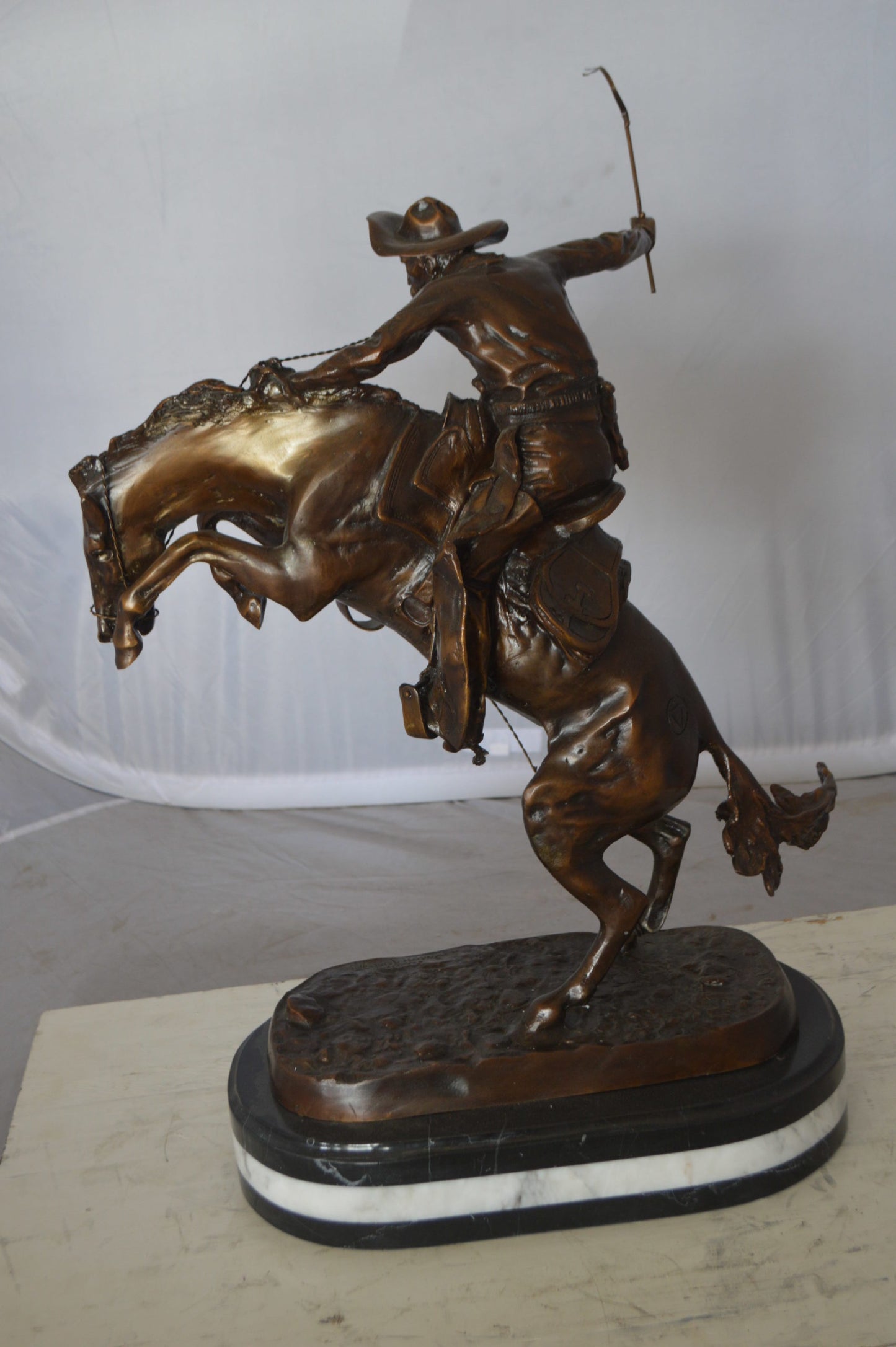 Bronco Buster by Remington Bronze Statue on a triple marble - 21"x 10"x 26"H.