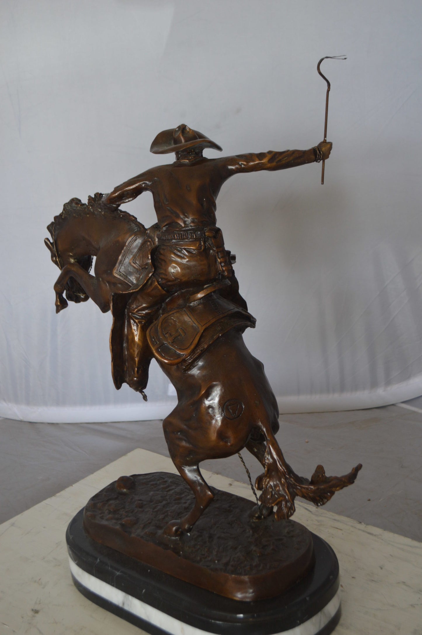 Bronco Buster by Remington Bronze Statue on a triple marble - 21"x 10"x 26"H.