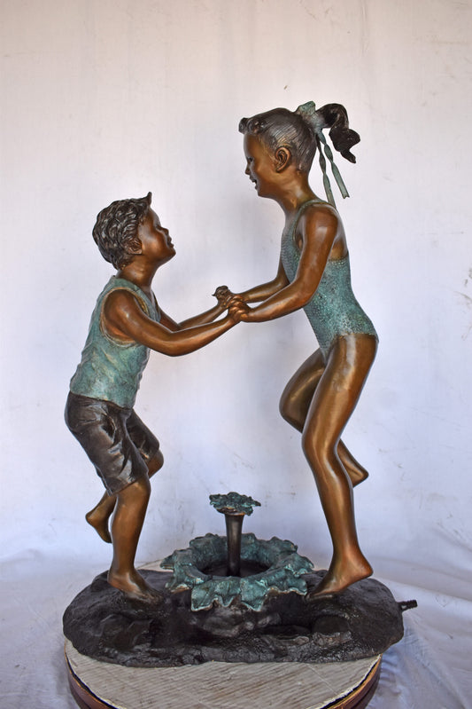 Young Boy and girl dancing around fountain bronze statue-Size 28" x 13" x 38"H