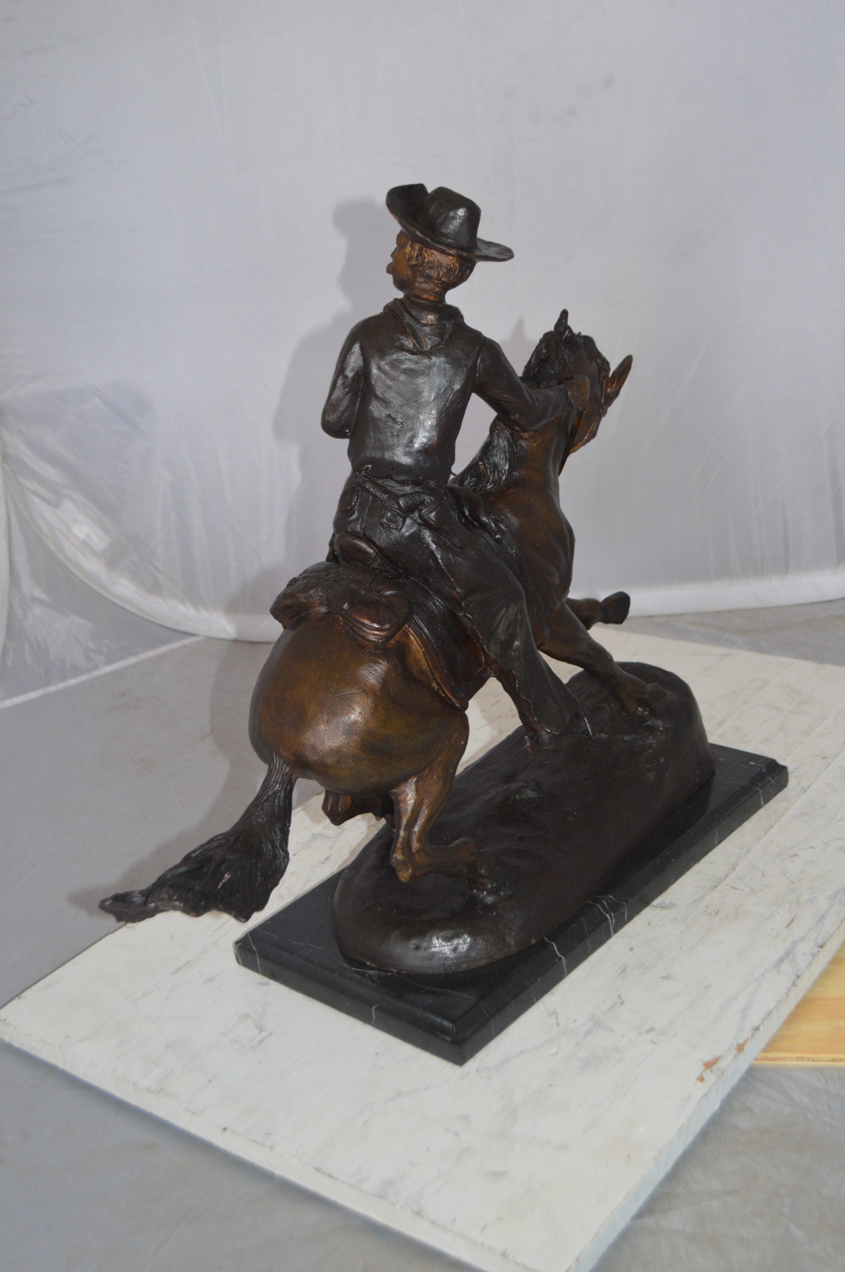 Remington Cowboy on marble Bronze Statue -  Size: 24"L x 9"W x 23"H.