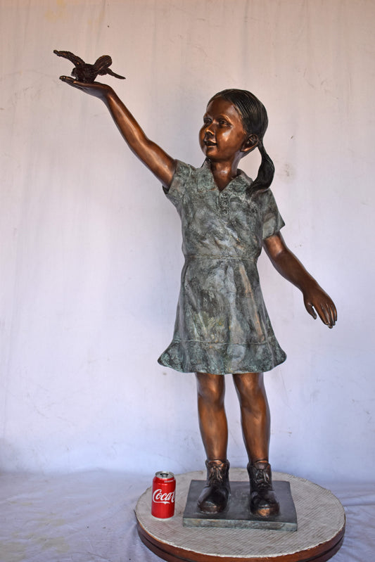 Young Girl Holding a Bird Outside at The Park - Size: 21"L x 11"W x 49"H.