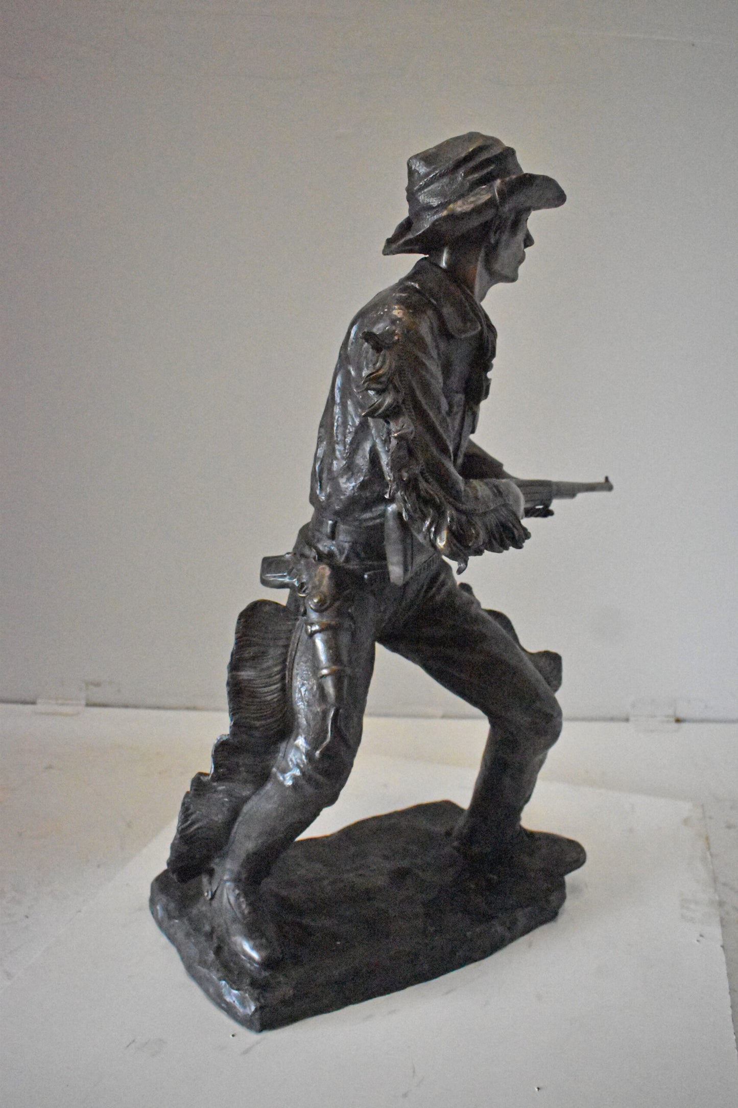 Cowboy with His Gun Bronze Statue - Size: 26"L x 13"W x 33"H.