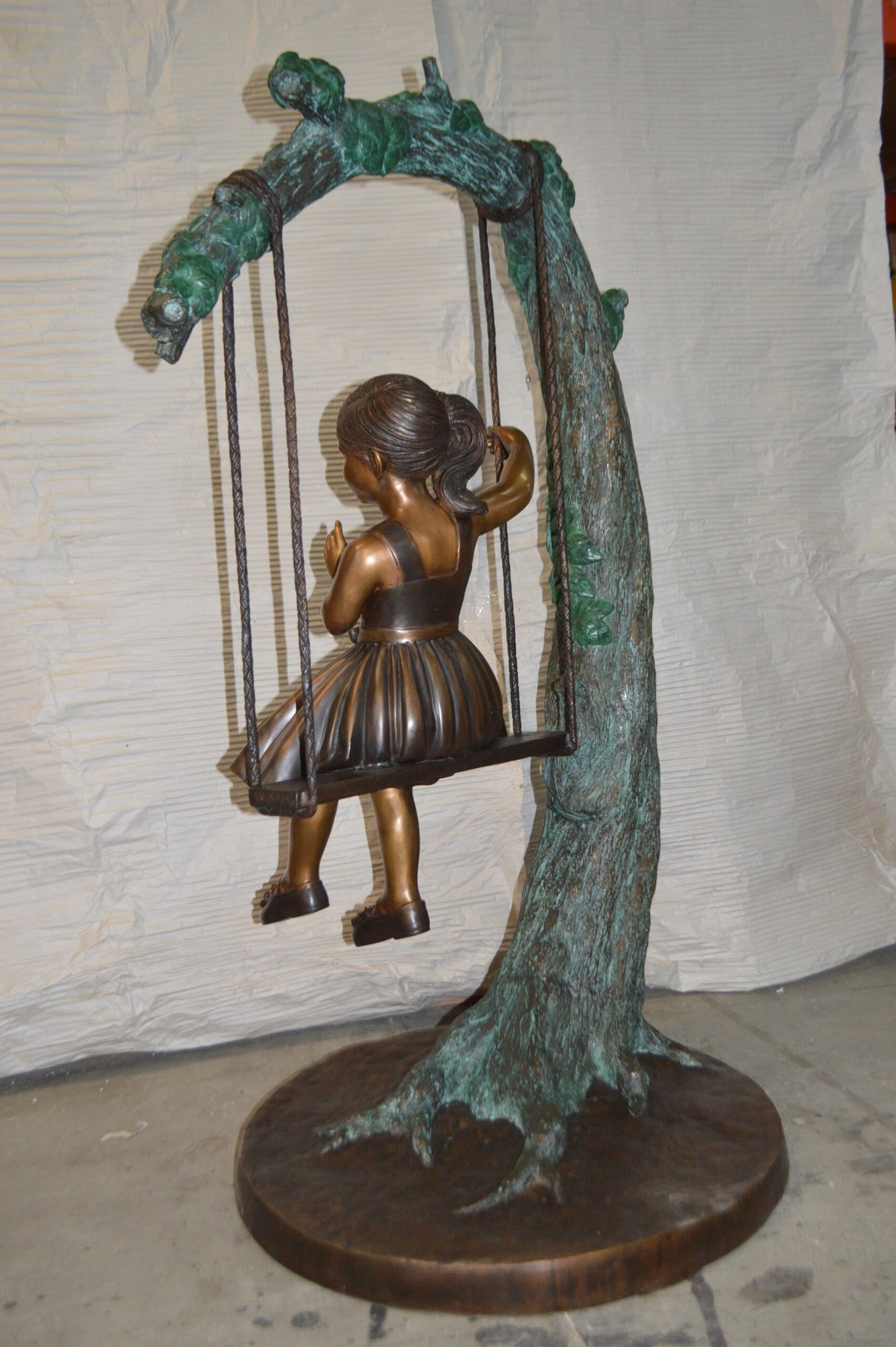 Girl on Swing 65 Bronze Statue - Size: 44"L x 35"W x 65"H.