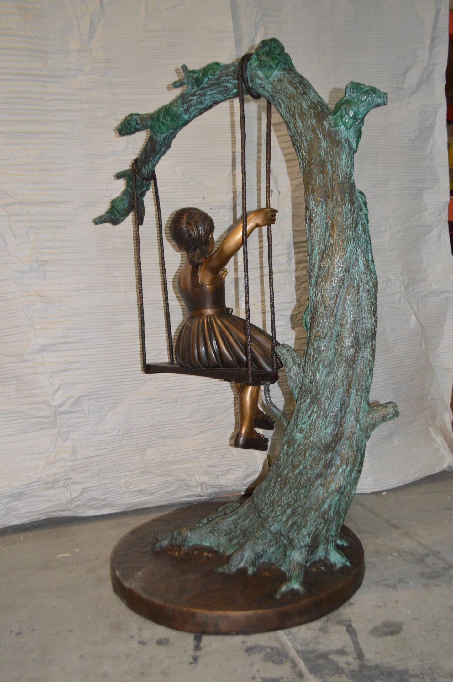 Girl on Swing 65 Bronze Statue - Size: 44"L x 35"W x 65"H.
