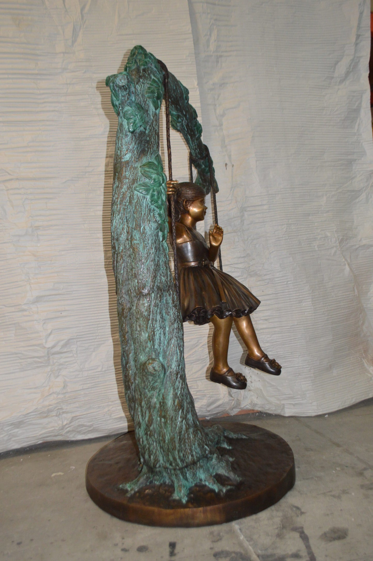 Girl on Swing 65 Bronze Statue - Size: 44"L x 35"W x 65"H.