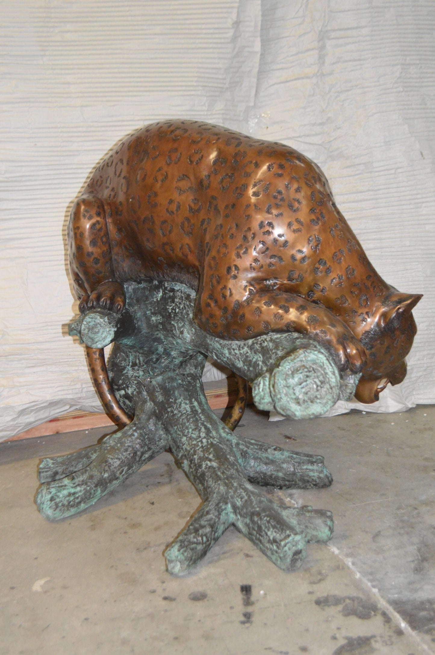Leopard on a Tree Trunk Bronze Statue - Size: 38"L x 34"W x 36"H.