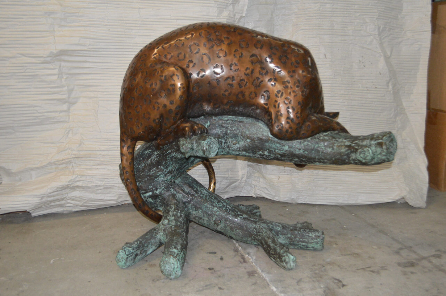Leopard on a Tree Trunk Bronze Statue - Size: 38"L x 34"W x 36"H.