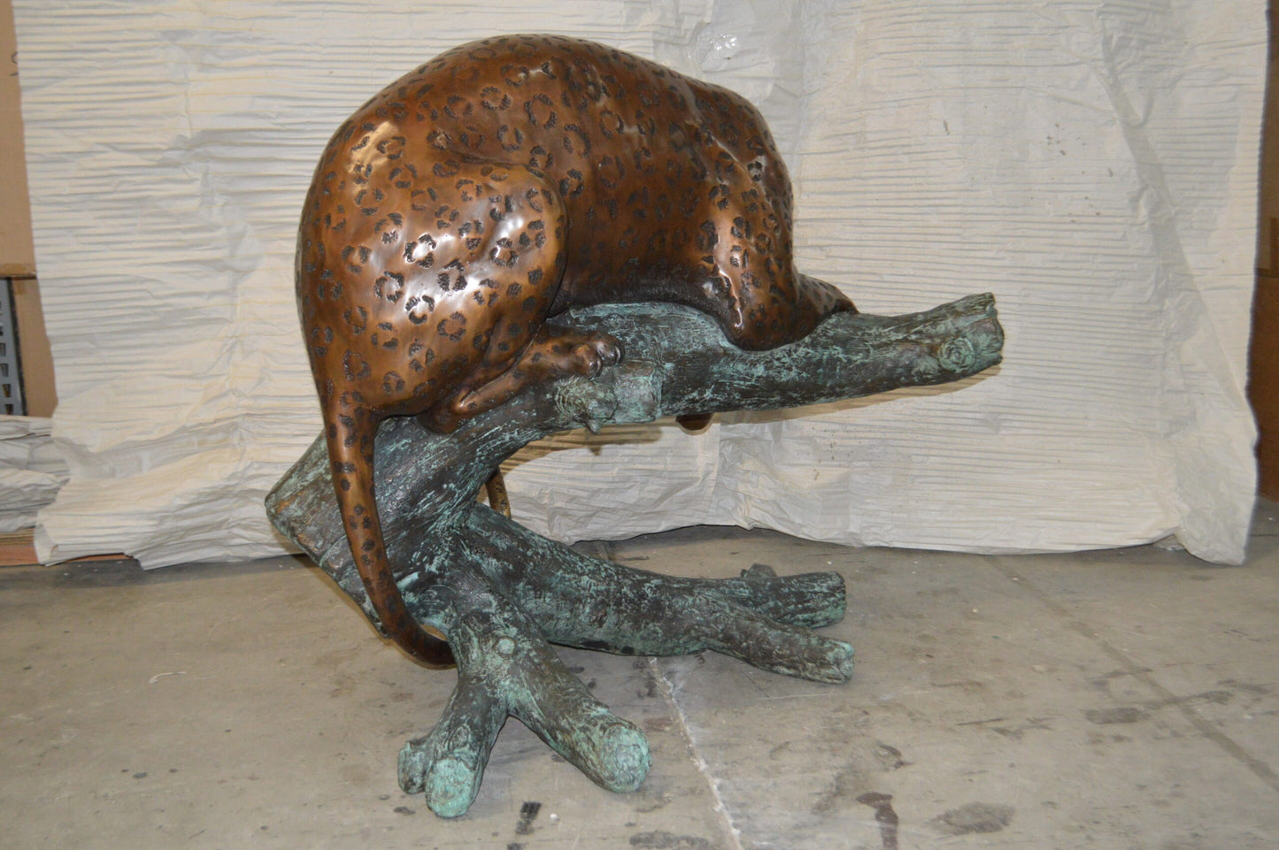 Leopard on a Tree Trunk Bronze Statue - Size: 38"L x 34"W x 36"H.