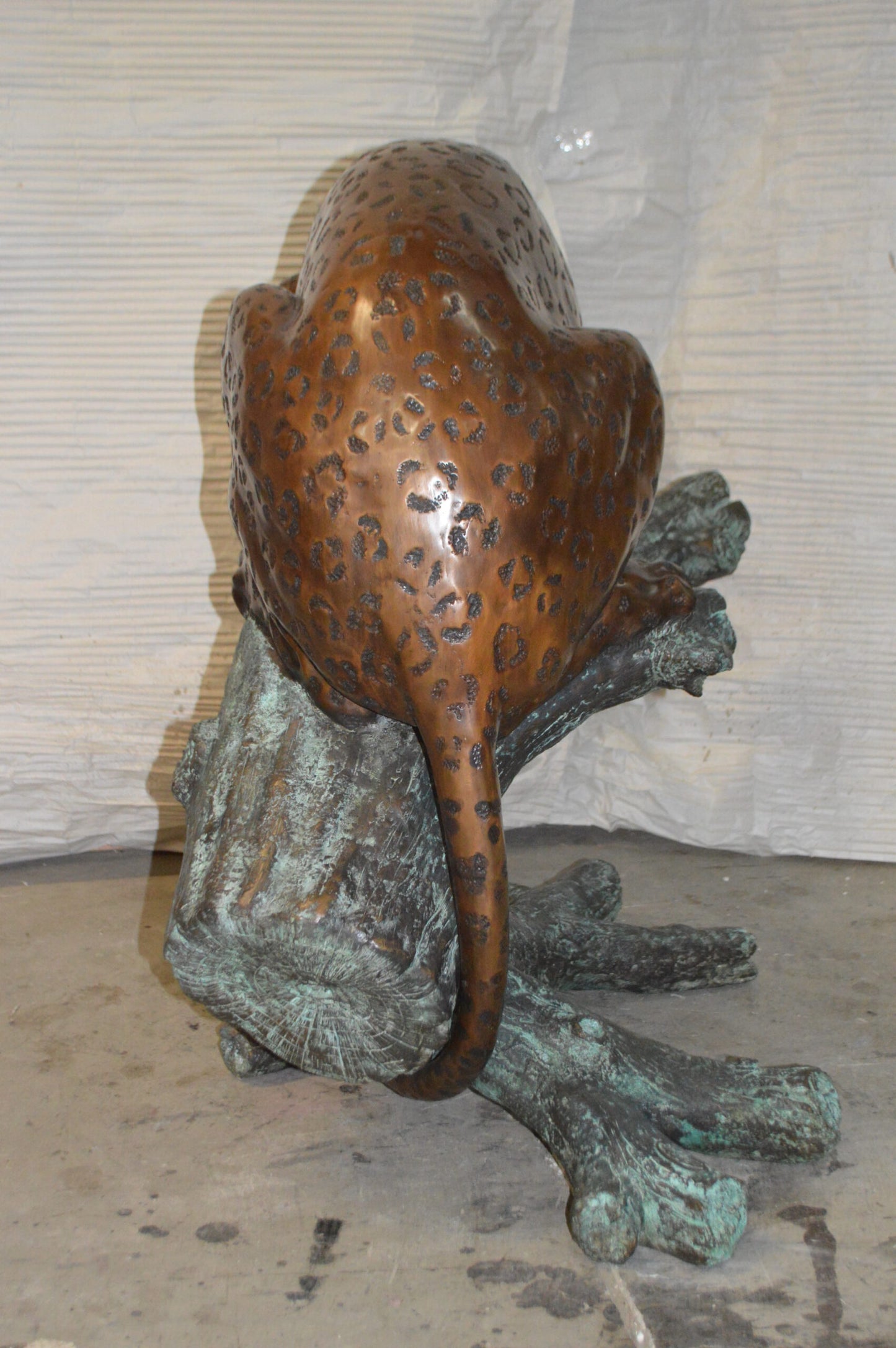 Leopard on a Tree Trunk Bronze Statue - Size: 38"L x 34"W x 36"H.
