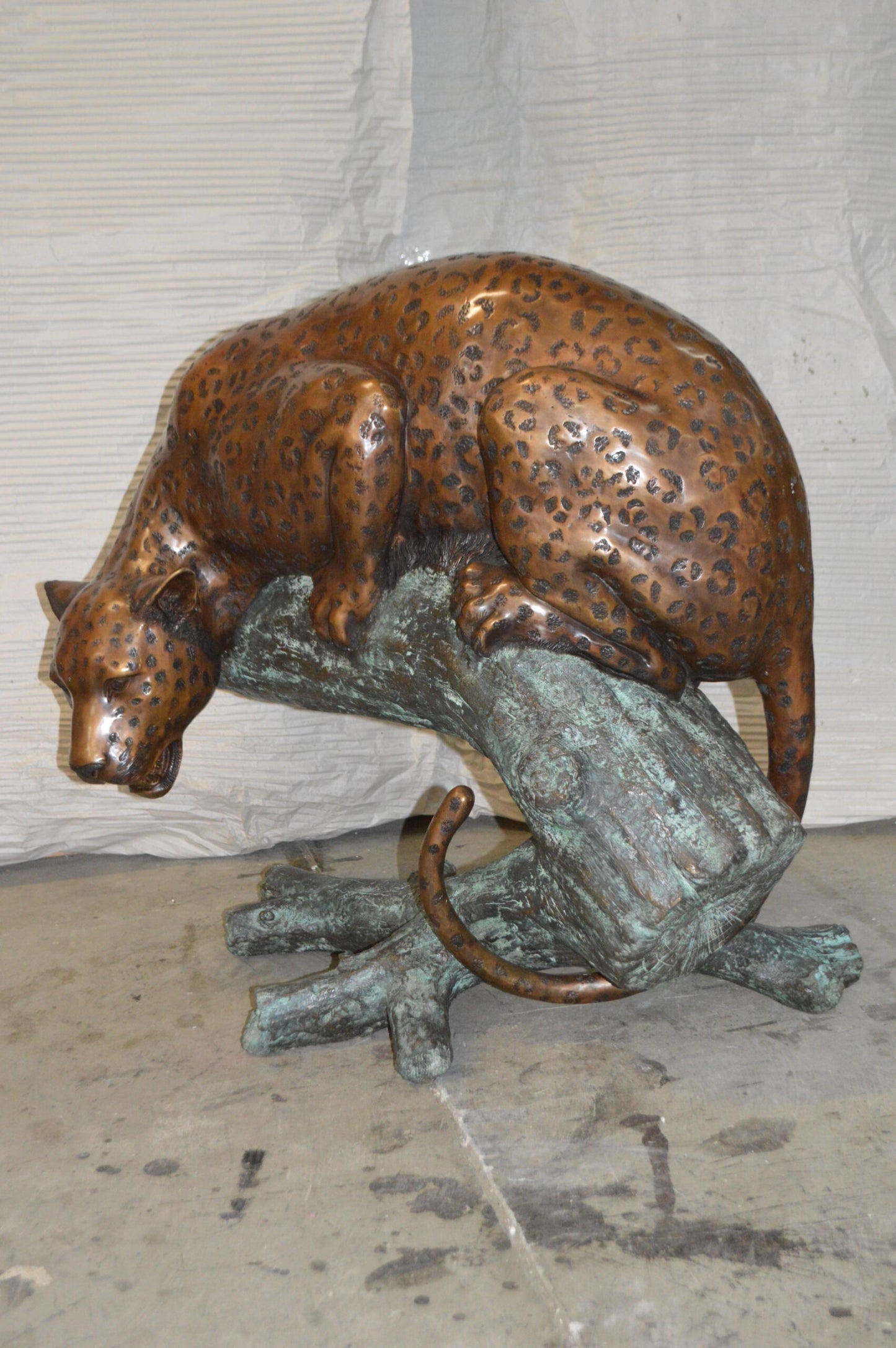 Leopard on a Tree Trunk Bronze Statue - Size: 38"L x 34"W x 36"H.
