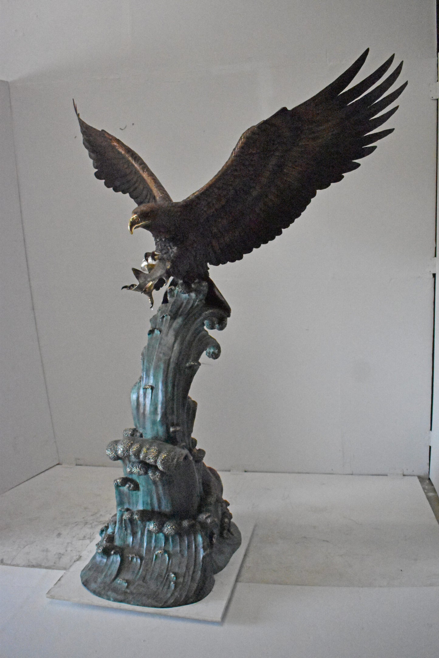 Eagle in Action Catching His Prey Bronze Statue - Size: 68"L x 40"W x 87"H.