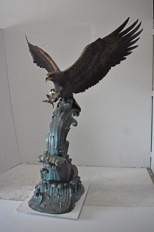 Eagle in Action Catching His Prey Bronze Statue - Size: 68"L x 40"W x 87"H.