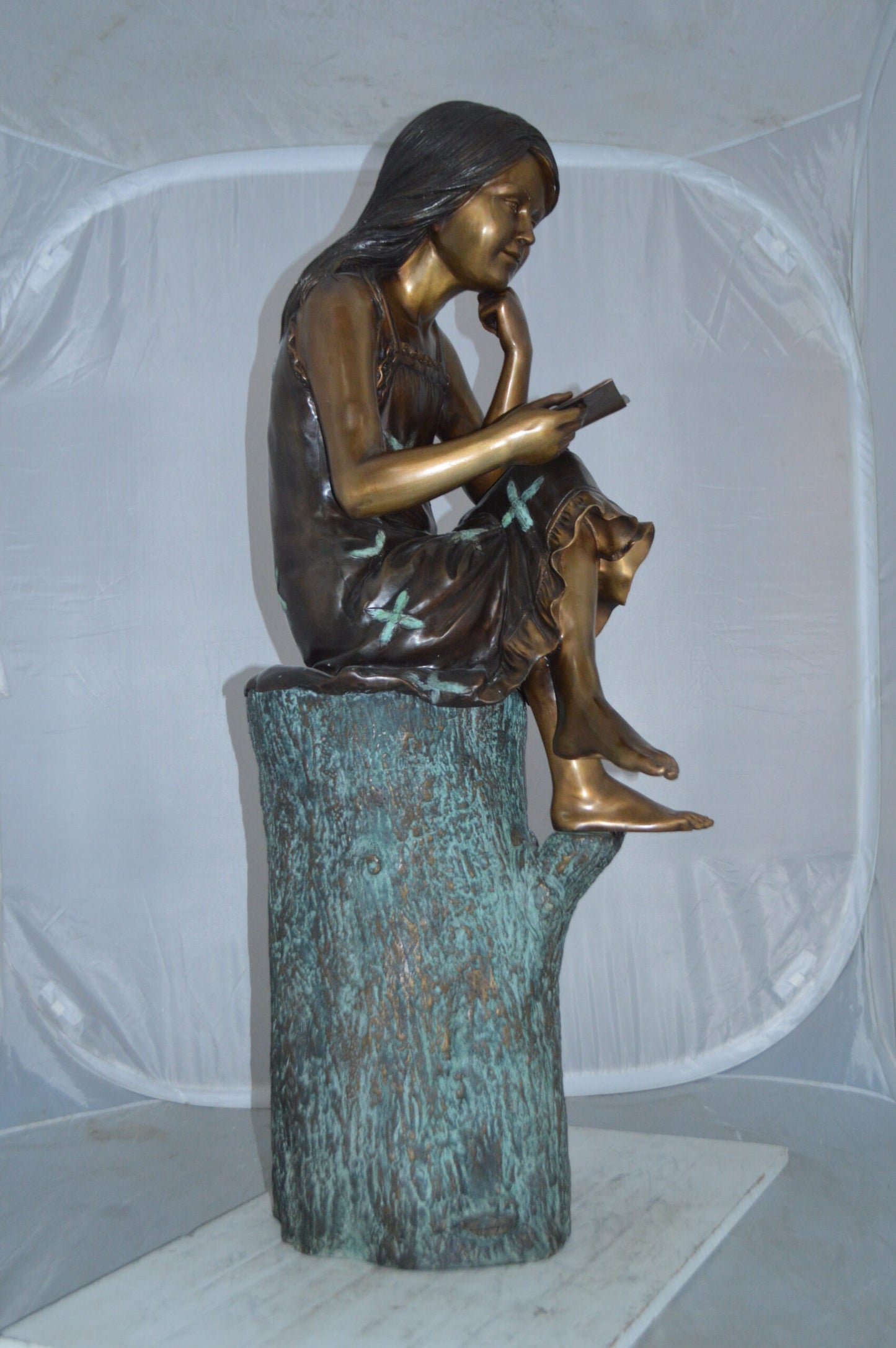 Sitting Girl on Log Reading a Book Bronze Statue - Size: 19"L x 13"W x 48"H.