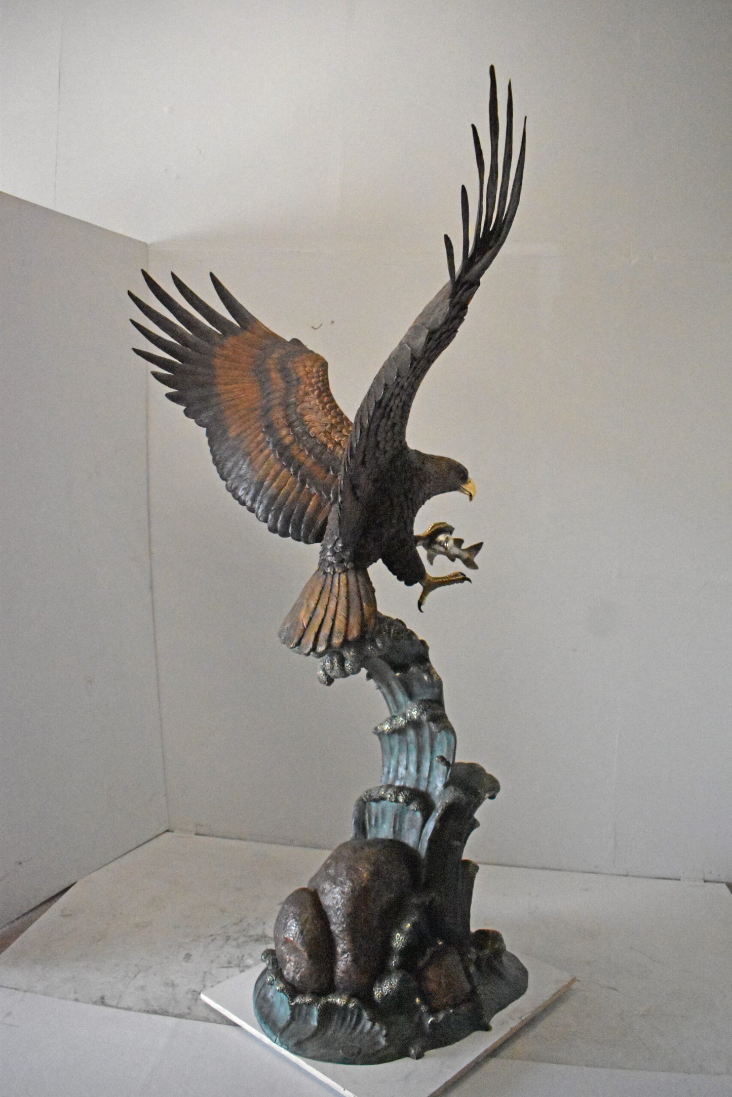 Eagle in Action Catching His Prey Bronze Statue - Size: 68"L x 40"W x 87"H.