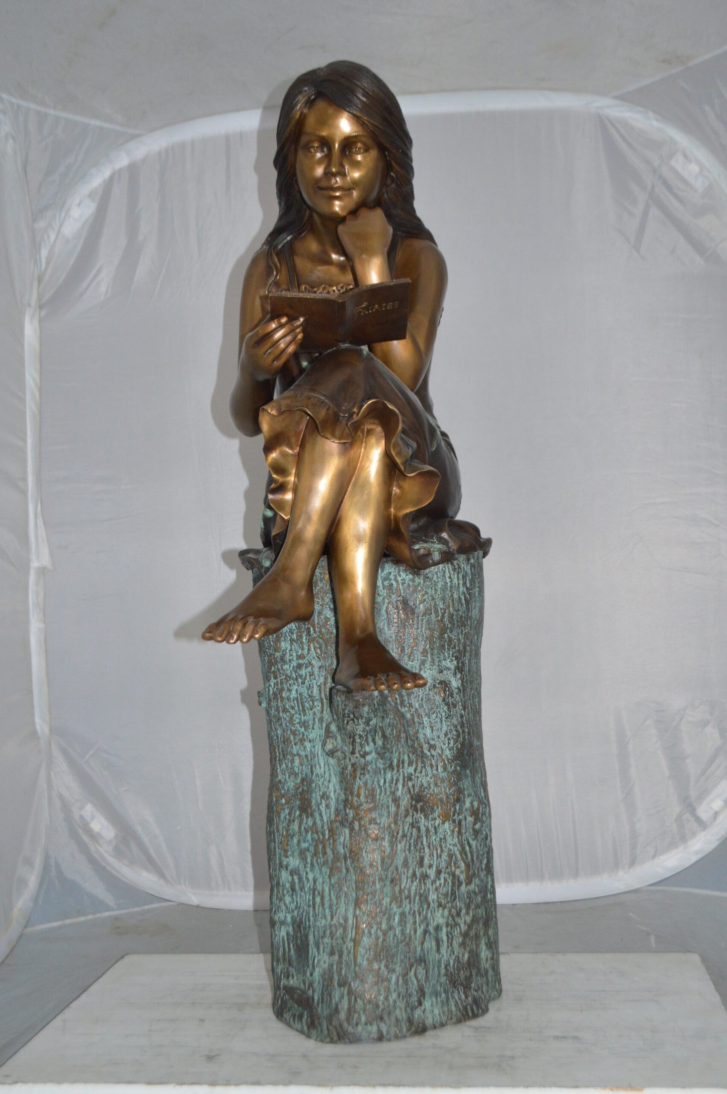 Sitting Girl on Log Reading a Book Bronze Statue - Size: 19"L x 13"W x 48"H.